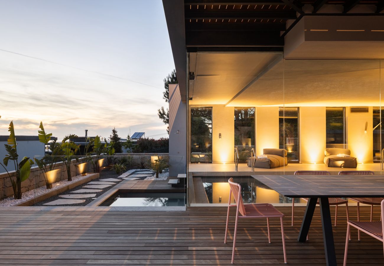 Outdoor dinning area by the pool with sea views